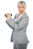 Shocked businesswoman with binoculars