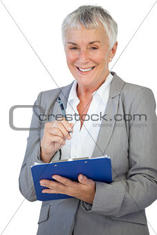 Smiling businesswoman holding her clipboard