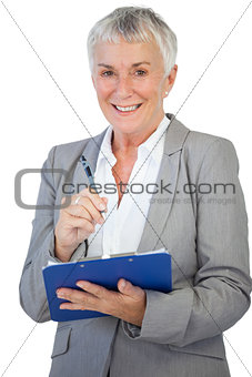 Happy businesswoman using her clipboard