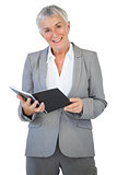 Happy businesswoman holding notepad