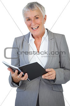 Cheerful businesswoman holding notepad