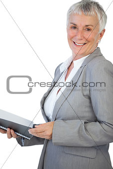 Smiling businesswoman holding notepad