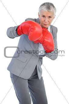 Businesswoman boxing with her boxing gloves