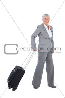 Smilling businesswoman with her luggage
