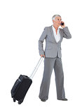 Businesswoman with her luggage and calling someone