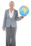 Happy businesswoman holding globe