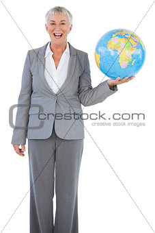 Happy businesswoman holding globe
