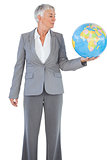 Businesswoman holding and looking at globe