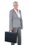 Serious businesswoman holding briefcase