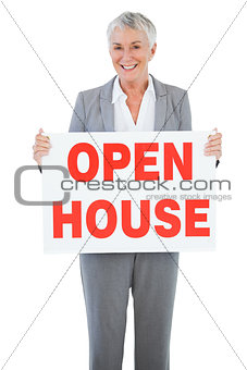 Estate agent holding sign for open house