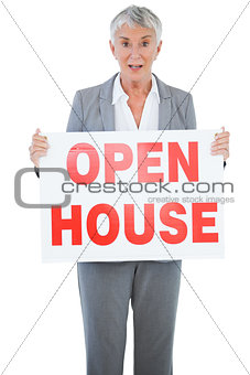 Surprised estate agent holding sign for open house