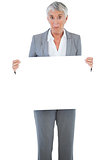 Businesswoman holding blank sign