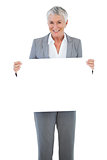 Smiling businesswoman holding blank sign