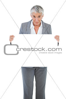 Happy businesswoman holding blank sign