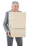 Happy businesswoman holding cardboard boxes