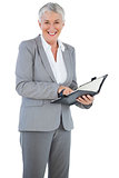 Smiling businesswoman holding her diary