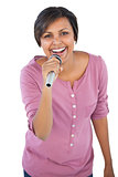 Brunette singing with her microphone