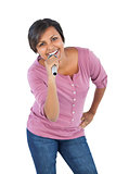 Smiling woman holding microphone for singing