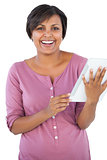 Happy woman holding tablet pc