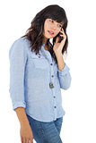 Brunette with her mobile phone calling someone
