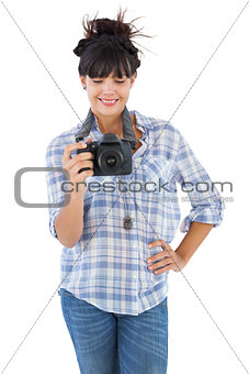 Young woman with hand on her hip taking picture