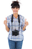 Woman with camera showing  thumbs up