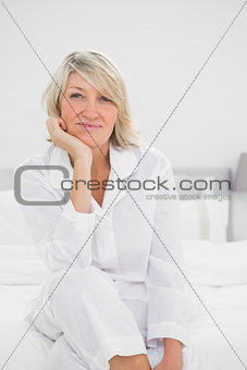 Cheerful  woman sitting in her bedroom