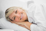 Blonde woman lying in her bed