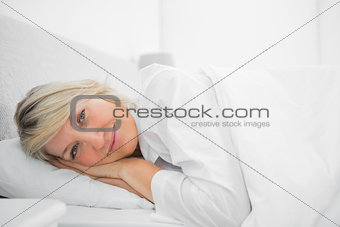 Relaxed woman lying in her bed
