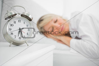 Blonde woman sleeping in bed
