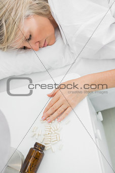 Blonde woman lying motionless after overdosing on pills
