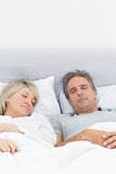 Couple sleeping soundly in their bed