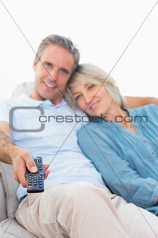 Cheerful couple on their couch watching tv