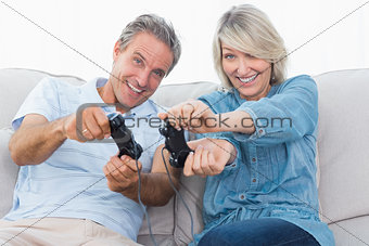 Couple playing video games on the sofa