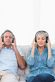 Couple relaxing and listening to music on the couch