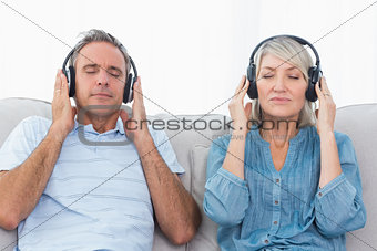 Couple listening to music on the couch
