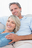 Smiling couple relaxing at home