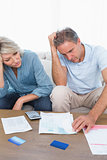 Anxious couple going over bills