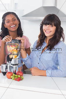 Cheerful friends about to make healthy juice