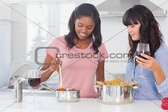 Happy friends making dinner together