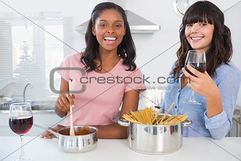 Cheerful friends preparing dinner together