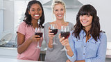 Happy friends enjoying glasses of red wine