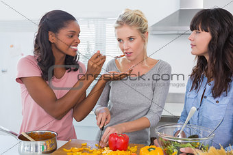 Cheerful friends preparing a meal together