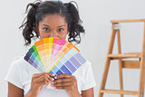 Happy woman showing colour charts