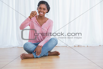Happy young woman showing her new house keys