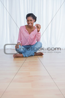 Cheerful young woman showing her new house keys