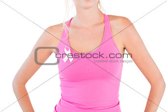 Woman wearing pink tank top and breast cancer ribbon