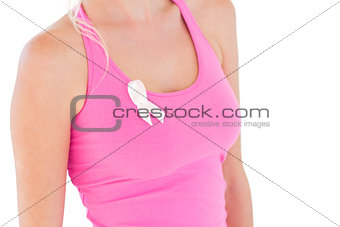 Woman wearing pink top and ribbon for breast cancer
