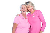 Mature women wearing pink tops and ribbons for breast cancer