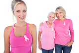 Three happy women wearing pink tops and breast cancer ribbons